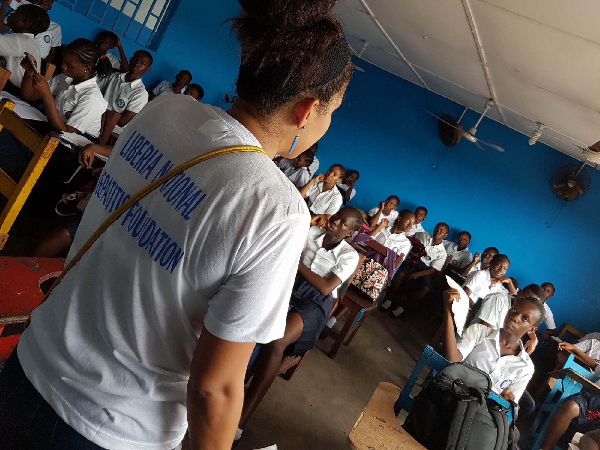 Lady Standing In Front Of The Students